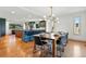Bright, open dining area with stylish chandelier, hardwood floors, and an eat-in kitchen island at 6388 Donner Cir, Parker, CO 80134