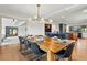 Spacious dining room with a large wood table, stylish lighting, and hardwood flooring at 6388 Donner Cir, Parker, CO 80134