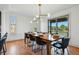 Dining area with hardwood floors, modern lighting, and sliding glass doors to the outside at 6388 Donner Cir, Parker, CO 80134