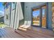 Stylish front entry with stained wood door, a wooden deck and a peek at the exterior of the house at 6388 Donner Cir, Parker, CO 80134