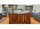 Modern kitchen featuring a large island with seating, stainless steel appliances, and sleek countertops at 6388 Donner Cir, Parker, CO 80134