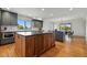 Spacious kitchen featuring a large kitchen island, hardwood floors, modern appliances, and an airy dining area at 6388 Donner Cir, Parker, CO 80134