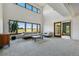 Bright living room with vaulted ceilings, large windows, and neutral-toned furniture at 6388 Donner Cir, Parker, CO 80134