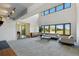 Bright living room with vaulted ceilings, large windows, and neutral-toned furniture at 6388 Donner Cir, Parker, CO 80134