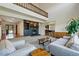 Spacious living room with modern fireplace and stylish decor, adjacent to the kitchen at 6388 Donner Cir, Parker, CO 80134