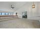 A carpeted loft area with a wood railing and an adjacent bedroom view, offering a versatile living space at 6388 Donner Cir, Parker, CO 80134