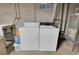 Basement laundry area with washer, dryer, and water heater, showcasing functional space at 4483 S Eagle Cir, Aurora, CO 80015