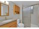 Clean bathroom features a granite vanity, toilet, and shower with glass doors at 4483 S Eagle Cir, Aurora, CO 80015