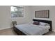 Bedroom featuring carpeted floors, a comfortable bed, and a large window overlooking greenery at 4483 S Eagle Cir, Aurora, CO 80015