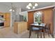 Bright dining area with modern light fixture and a large cabinet with mirrored door at 4483 S Eagle Cir, Aurora, CO 80015