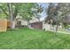 Spacious front yard featuring mature landscaping with mature trees and a two-car garage at 4483 S Eagle Cir, Aurora, CO 80015