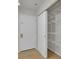 Hallway featuring hardwood floors and a closet with wire shelves, offering storage solutions at 4483 S Eagle Cir, Aurora, CO 80015