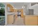 Open kitchen featuring stainless steel appliances, light wood cabinetry, and granite countertops by a glass patio door at 4483 S Eagle Cir, Aurora, CO 80015