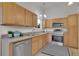 Well-lit kitchen featuring stainless steel appliances and light wood cabinetry at 4483 S Eagle Cir, Aurora, CO 80015
