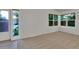 Sunlit living room with neutral carpet and large windows offering green views at 4483 S Eagle Cir, Aurora, CO 80015
