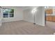 Spacious living room filled with natural light, neutral carpet, with a view of the kitchen at 4483 S Eagle Cir, Aurora, CO 80015