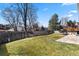 Expansive backyard with lush green grass, a fenced perimeter, and an inviting patio at 6866 W David Ave, Littleton, CO 80128