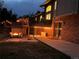 Evening backyard view showcasing an inviting patio with a fire pit and a hot tub at 6866 W David Ave, Littleton, CO 80128