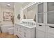 Modern bathroom with double sinks, a large mirror, and a soaking tub at 6866 W David Ave, Littleton, CO 80128