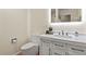 Modern bathroom featuring a sleek vanity with undermount sink, LED mirror, and a toilet at 6866 W David Ave, Littleton, CO 80128