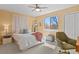 Bright bedroom featuring a ceiling fan, large window, and stylish decor at 6866 W David Ave, Littleton, CO 80128