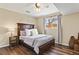 Cozy bedroom with a wood-framed bed, hardwood floors, and a ceiling fan at 6866 W David Ave, Littleton, CO 80128