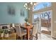 Dining room with modern decor, large windows, and access to an outdoor deck at 6866 W David Ave, Littleton, CO 80128