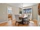 Dining area features a modern chandelier, large window, and seating for six at 6866 W David Ave, Littleton, CO 80128