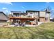 Exterior view of a home with a spacious backyard featuring a patio and a hot tub at 6866 W David Ave, Littleton, CO 80128