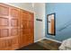 Bright foyer with unique floor tiles, a statement mirror, and a wooden double door at 6866 W David Ave, Littleton, CO 80128