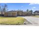 Well-maintained, single-story home featuring a brick facade and an expansive, paved driveway at 6866 W David Ave, Littleton, CO 80128