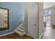 Hallway with tiled floors, a carpeted staircase and a view of the breakfast area at 6866 W David Ave, Littleton, CO 80128