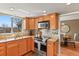 Well-lit kitchen with wood cabinets, stainless steel appliances and large window at 6866 W David Ave, Littleton, CO 80128