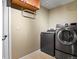 Laundry room with modern washer and dryer units and tiled floor at 6866 W David Ave, Littleton, CO 80128