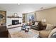 Cozy living room features a white brick fireplace, built-in shelves, and comfortable leather seating at 6866 W David Ave, Littleton, CO 80128