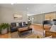 Open-concept living room flows seamlessly into the dining area with natural light at 6866 W David Ave, Littleton, CO 80128