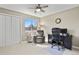 Office featuring a ceiling fan, large window, a desk and chair, and neutral-toned walls at 6866 W David Ave, Littleton, CO 80128