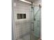 Modern shower with glass door, rain shower head, and a built-in niche at 6866 W David Ave, Littleton, CO 80128