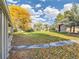 Lush backyard with a covered patio, a small outbuilding, and beautiful landscaping, creating a peaceful retreat at 8700 Flintwood Rd, Parker, CO 80138