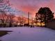 Snowy backyard at sunset, featuring mature trees and a serene winter atmosphere at 8700 Flintwood Rd, Parker, CO 80138