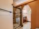 Stylish bathroom featuring a tiled shower with glass door and a wood vanity with granite countertop at 8700 Flintwood Rd, Parker, CO 80138