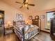 Charming bedroom with a wooden bed frame, ceiling fan, and a window overlooking the yard at 8700 Flintwood Rd, Parker, CO 80138