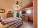 Inviting bedroom featuring hardwood floors, vaulted ceiling, and abundant natural light from multiple windows at 8700 Flintwood Rd, Parker, CO 80138