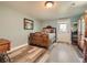 Charming bedroom featuring wood accents, a comfortable bed, and ample natural light at 8700 Flintwood Rd, Parker, CO 80138