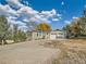 Exterior of house with inviting driveway and mature trees at 8700 Flintwood Rd, Parker, CO 80138