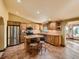 Well-lit kitchen with stainless steel appliances, island with seating, and tile flooring at 8700 Flintwood Rd, Parker, CO 80138