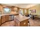 Open-concept kitchen featuring tile floors, wooden cabinets, and granite countertops at 8700 Flintwood Rd, Parker, CO 80138