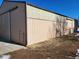 Side view of a large outbuilding with neutral siding and minimal landscaping around it at 8700 Flintwood Rd, Parker, CO 80138