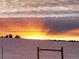 Gorgeous winter sunset over a snow-covered field at 8700 Flintwood Rd, Parker, CO 80138