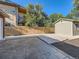 Spacious backyard featuring a concrete patio, privacy fence, and detached garage at 1731 Uinta St, Denver, CO 80220